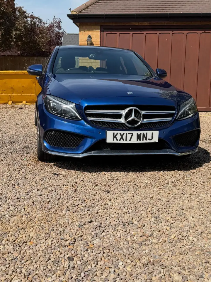 Blue Mercedes C-Class after an exterior detail on a home driveway
