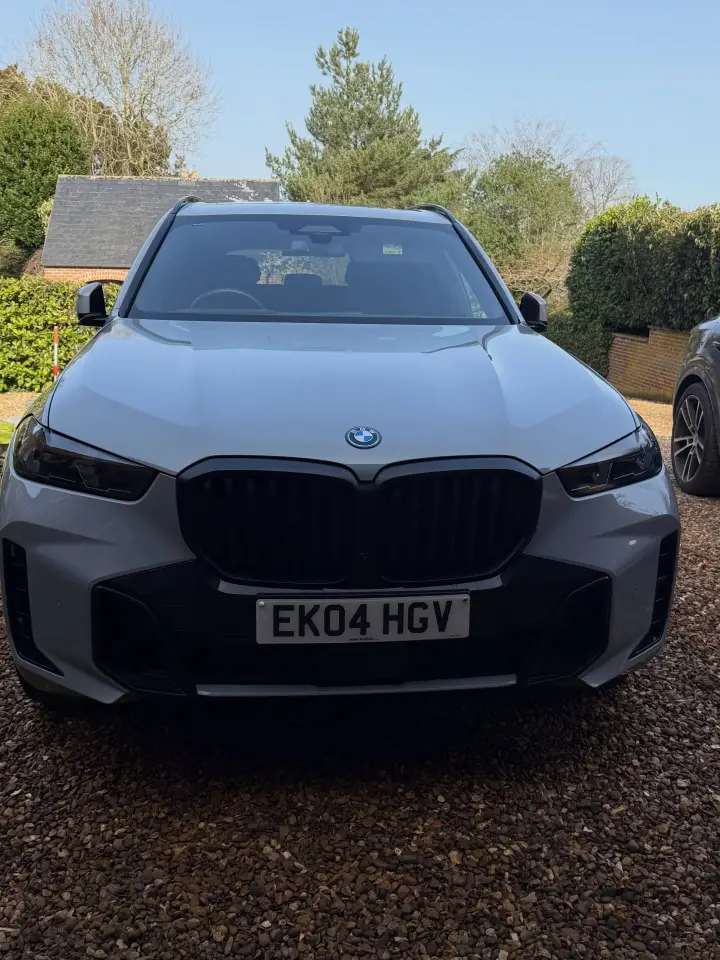 Grey BMW X5 with freshly detailed paintwork on a driveway