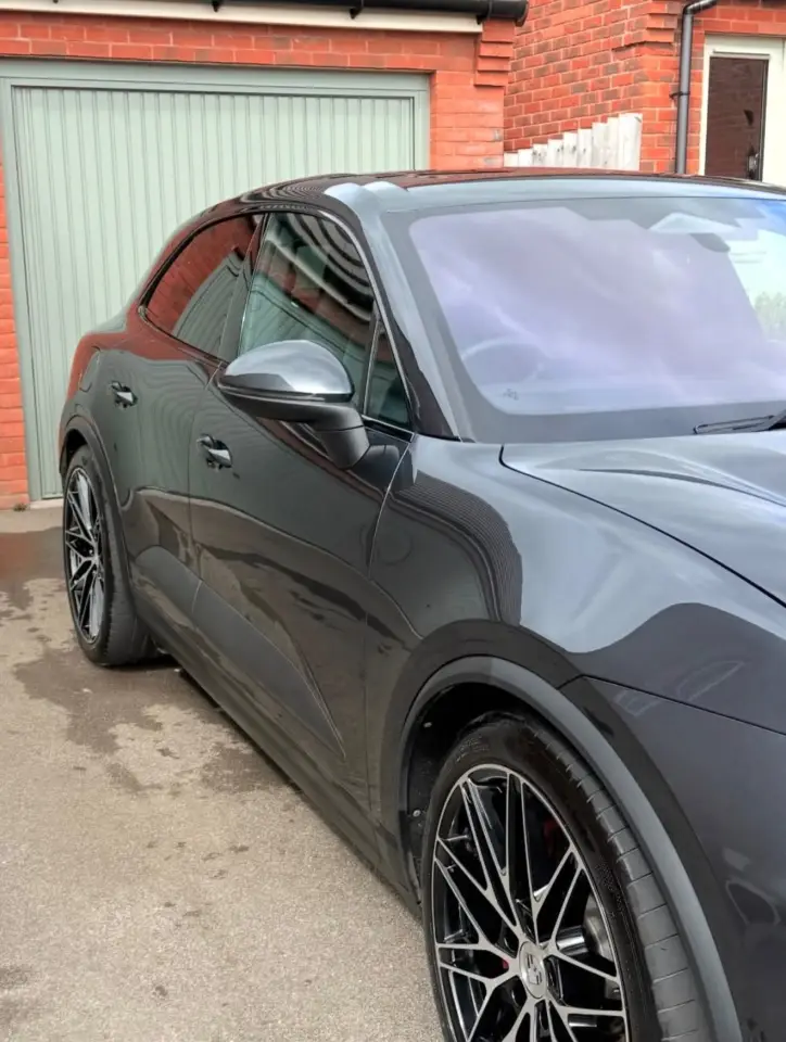 Grey Porsche Cayenne after a mobile detail outside a garage