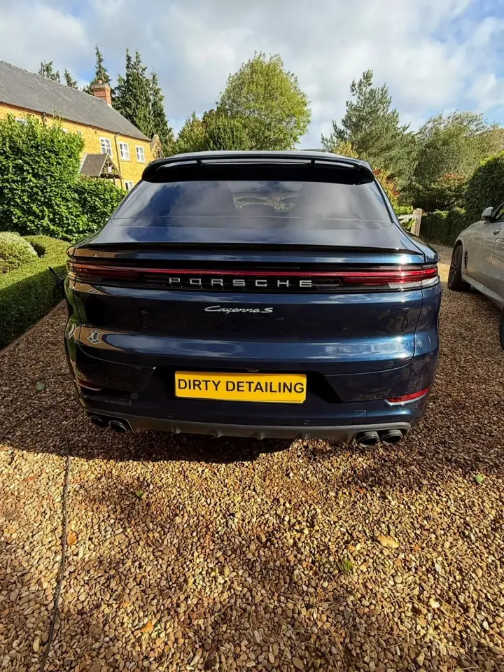 Porsche Cayenne detailed on a driveway beside a lawn