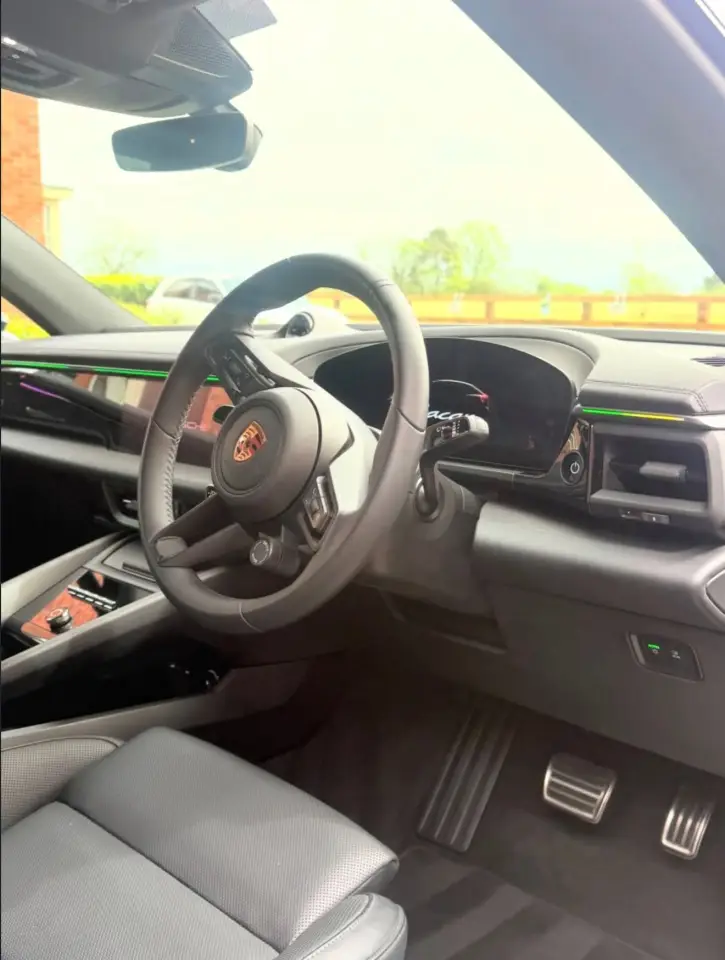 Detailed Porsche interior with clean steering wheel and dashboard